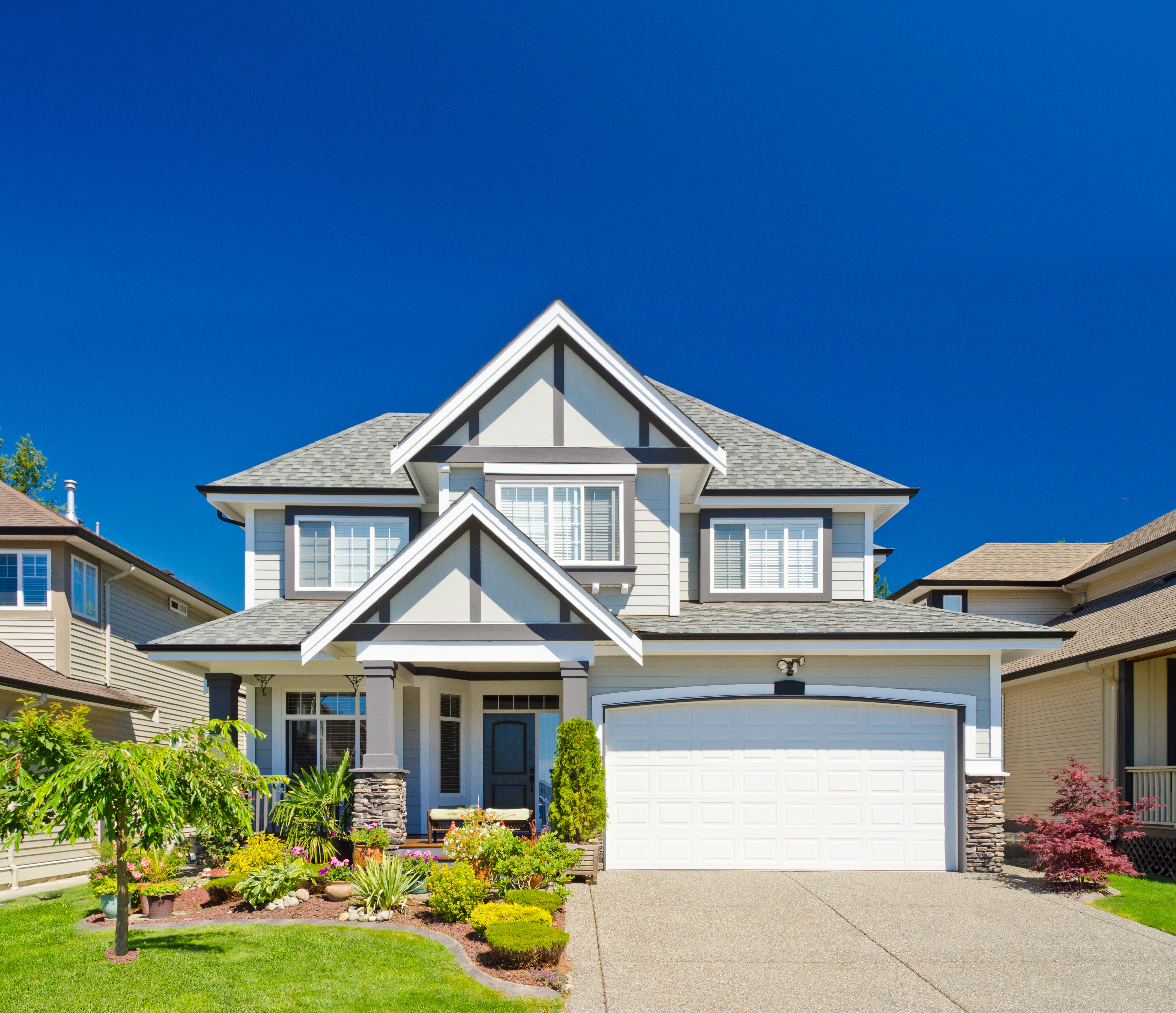 Homeowner relaxing in front of their house